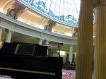 Salón principal del Hotel Carlton en Bilbao con piano de cola y cúpula de cristal
